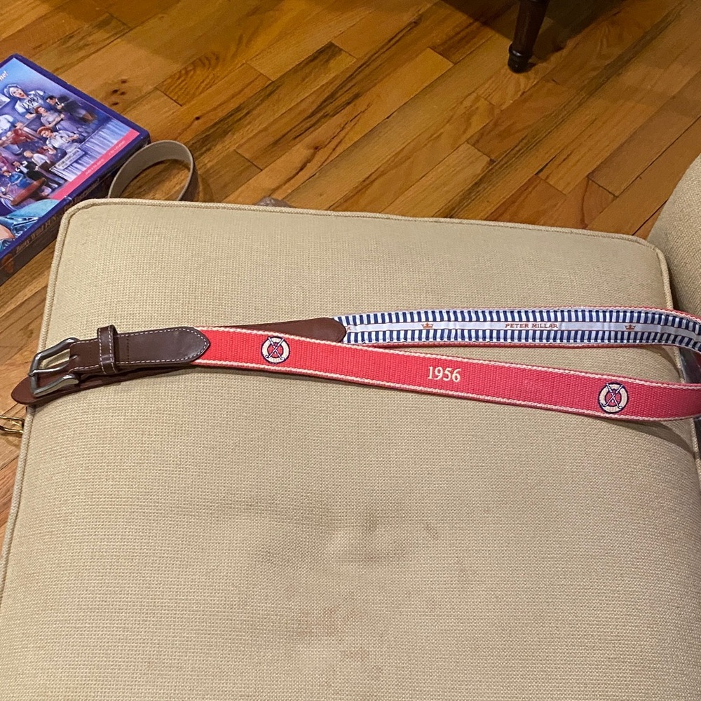 Peter Millar belt with 1956 on belt and golf clubs.